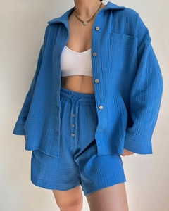 Detailed texture of royal blue crinkled fabric on casual shirt with wood-like buttons