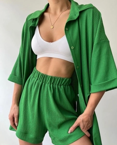 Detail view of grass green waffle textured summer set with button shirt and elastic shorts