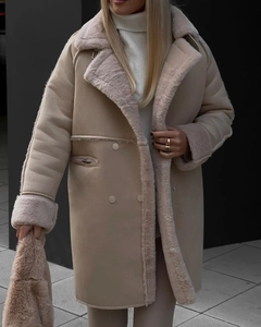 Close-up of beige faux suede long coat with plush fur lining and wide lapels