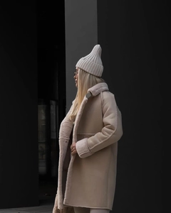 Detail view of winter beige faux suede long coat with plush lining and matching knit hat