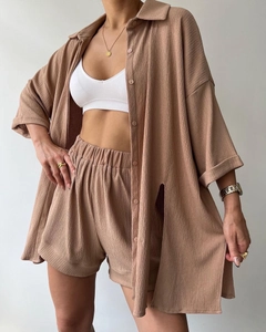 Detail of tan casual two-piece set showing natural wrinkled fabric texture and high waist