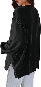 Detail van oversized sweatshirt met zijsplitjes en zichtbare naden op de mouwen