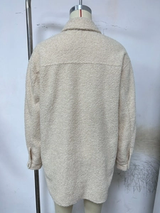 Detail view of beige fleece jacket back featuring loose fit and soft textured fabric