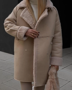 Detail of faux suede shearling coat featuring plush lapels and premium stitching texture