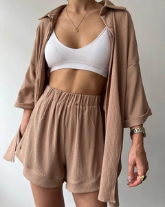 Detailed texture of brown seersucker shirt and shorts set with white tank top