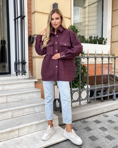 Detail of a purple wool shacket featuring chest pockets and oversized loose silhouette