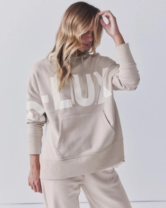 Detail of the high-quality cotton fabric and white D-LUXE print on beige hoodie set