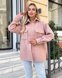 Detailed close-up of pink oversized sherpa shirt jacket with chest flap pockets