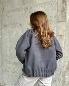 Back view of oversized charcoal grey fleece sweatshirt with elastic drawstring hem