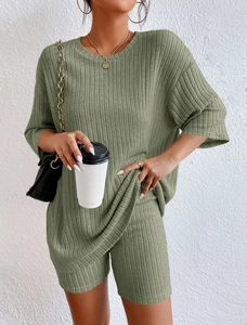 Detail view of olive green ribbed knit two-piece set with oversized top and high waist shorts