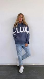 Detail of navy blue oversized hoodie with LUX print, side slits and kangaroo pocket