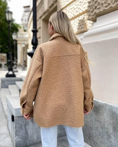 Back view of women's camel wool shirt jacket featuring drop shoulder design and loose fit