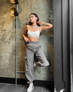 Detailed view of women's grey high-waisted cargo pants with side flap pockets and elastic waist