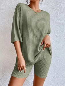 Detailed texture of olive green ribbed knit fabric on a casual loose two-piece set