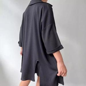 Women's black oversized split-hem shirt and shorts set with pleated texture fabric
