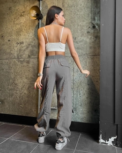 Rear view of high waist loose cargo pants with large pockets and elastic cuffs
