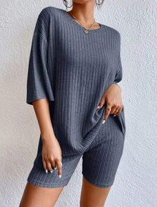 Detailed macro view of the ribbed knit fabric texture on this casual blue two-piece set