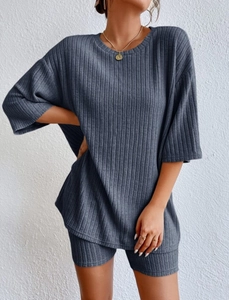 Detail of grey-blue ribbed knit loungewear set featuring a loose T-shirt and cycling shorts