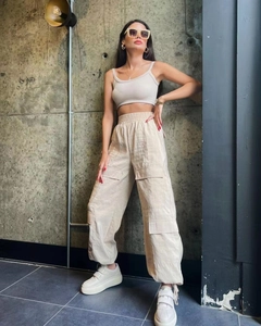 Detail of high waist cargo pants and ribbed tank top set with functional pockets