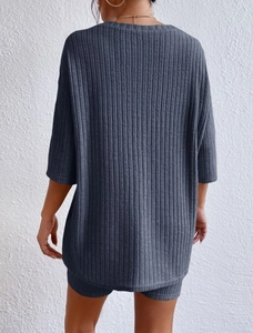Back view of loose dark gray ribbed knit two-piece set with long T-shirt and shorts