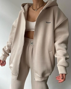 Detail of cream fleece-lined oversized hoodie set with black MAI STUDIOS logo print