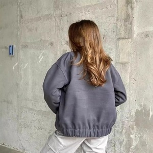 Back view of dark grey oversized drop shoulder jacket with elasticated hem for women