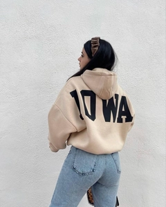 Detalle de sudadera beige oversize con estampado IOWA en la espalda y hombros caídos
