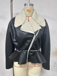 Close-up of black faux leather jacket with cream shearling collar and peplum hem details
