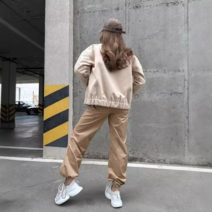 Women's casual light beige zip-up jacket with elastic hem and khaki cargo pants