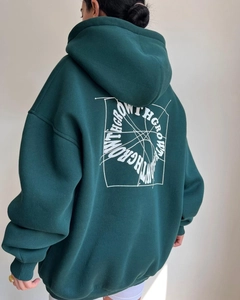 Dettaglio della felpa con cappuccio oversize verde scuro con stampa GROW WITH sul retro