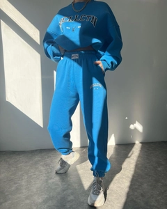 Detail of blue hoodie set with deer graphic print and elastic waistband with woven label