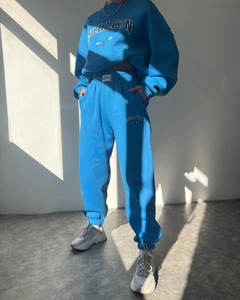 Detailed view of blue fleece track suit featuring MCLLCTN logo and soft cotton texture