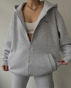 Detail of grey oversized zip-up hoodie and joggers set with MAI STUDIOS logo