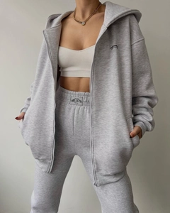 Detail of light grey hooded zipper tracksuit featuring soft cotton blend fabric and branding