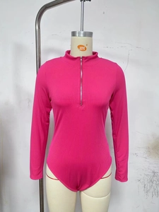 Close-up of ribbed rose pink bodysuit featuring a front zipper and high neck stand collar