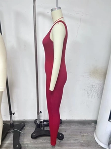 Detail view of the ribbed knit fabric and slim fit design of a burgundy bodysuit