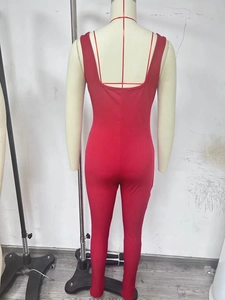 Close-up of red ribbed jumpsuit featuring backless U-neck design and slim fit cut