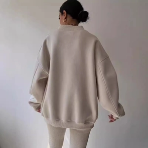 Women's oversized beige lounge set featuring a loose sweatshirt and matching slim pants
