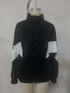 Detail of color block patchwork on black and white zip-up stand collar jacket