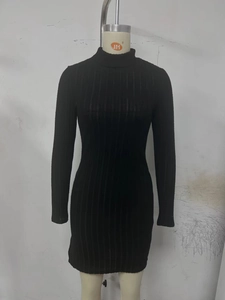 Detail of black ribbed knit long sleeve dress showing mock neck and slim fit texture