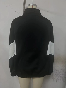 Detail view of sport jacket back featuring a distinctive black and white V-shaped color block