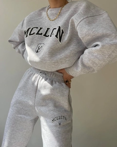 Close-up of grey fleece tracksuit with MCLLCTN letter print and thick cotton fabric