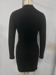 Close-up of black ribbed knit long sleeve dress with vertical texture and high neckline