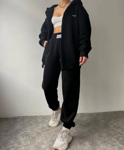 Detailed full-body view of women's black hooded fleece tracksuit with joggers
