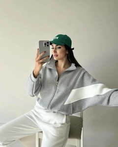 Detail of color-block casual grey and white loose zip-up sweatshirt on model