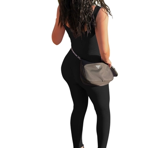 Rear view of a black ribbed sleeveless jumpsuit with an open back and bodycon fit