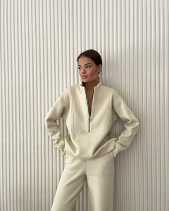 Detail of half-zip stand collar and thick fleece fabric on beige two-piece tracksuit set
