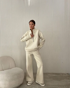Detail of beige half-zip sweatshirt and matching joggers set in premium thick fleece fabric