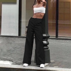 Women high waist black cargo pants with side flap pockets in a trendy street style look