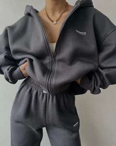 Close-up of dark grey heavy cotton tracksuit with MAI STUDIOS CO print detail